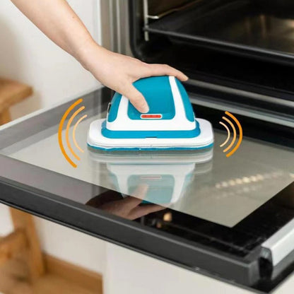 Cordless electric scrubber cleaning the glass door of an oven