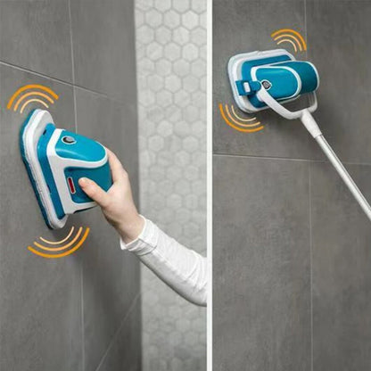 Woman scrubbing grey bathroom wall tiles with the electric multi scrubber